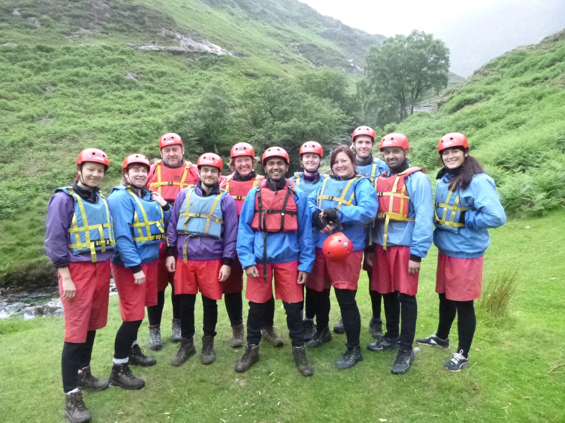 A team of teachers in buoyancy aids, helmets and water proofs